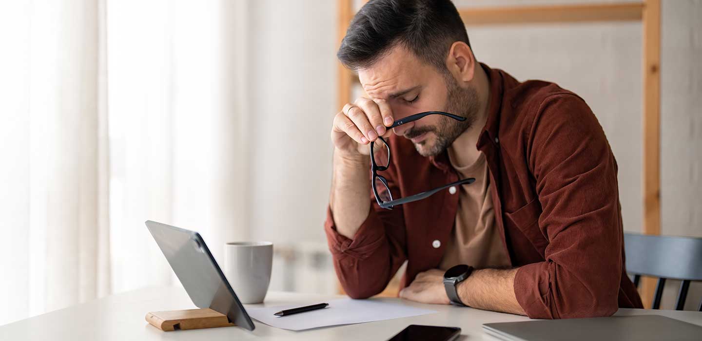 Person looking frustrate looking at computer.