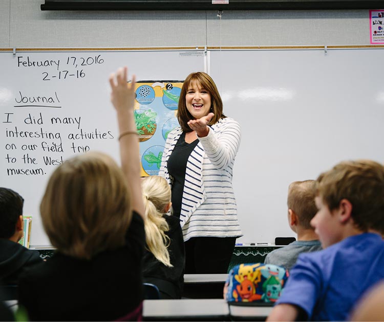 Woman teacher in classroom with children